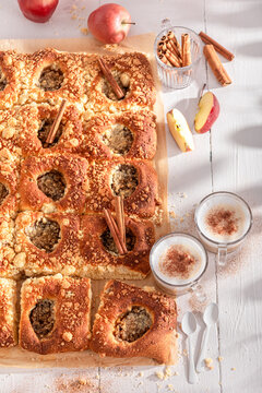 Delicious and hot apple yeast cake with milk and cinnamon.