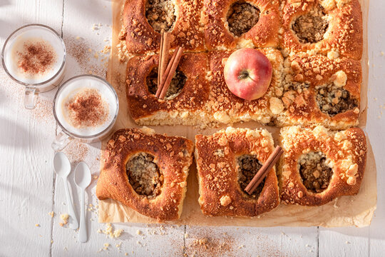 Homemade and sweet apple yeast cake with milk and cinnamon.