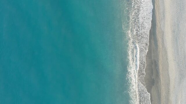 Turquoise sea surface with coastal waves