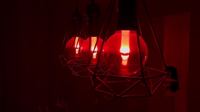 Three Red Glowing Lamps Filling Room with Sensual Atmospheric Red Light