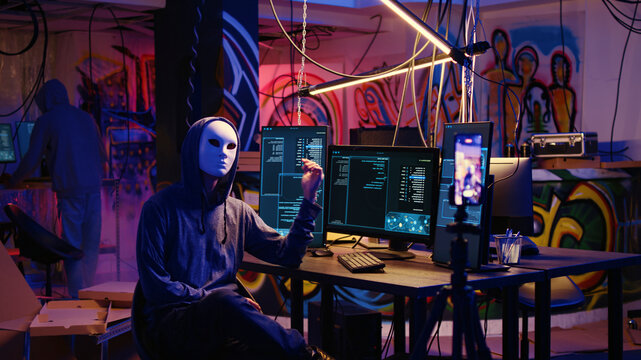 Dissident social justice crusaders doing online activism, wearing anonymous masks and filming video in underground bunker, blackmailing government after stealing secret military documents.