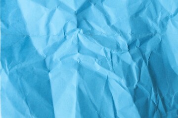 Obraz premium Top view of crumpled blue paper texture background, minimalist abstract backdrop with copy space for text.