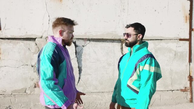 Confrontation Against Urban Backdrop. Urban Scene With Confrontational Men And Vibrant Fashion Contrast . Media