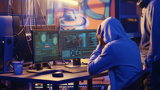 BIPOC hackers in secret headquarters targeting vulnerable unpatched connections, frustrated after failing to get past computer defenses and steal valuable sensitive data, access denied error.
