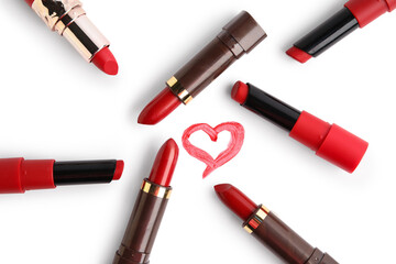 Obraz premium Red lipsticks with painted heart on white background