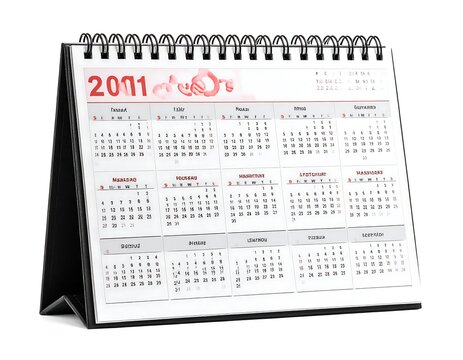 A spiral-bound desk calendar displaying the year 2011 in red