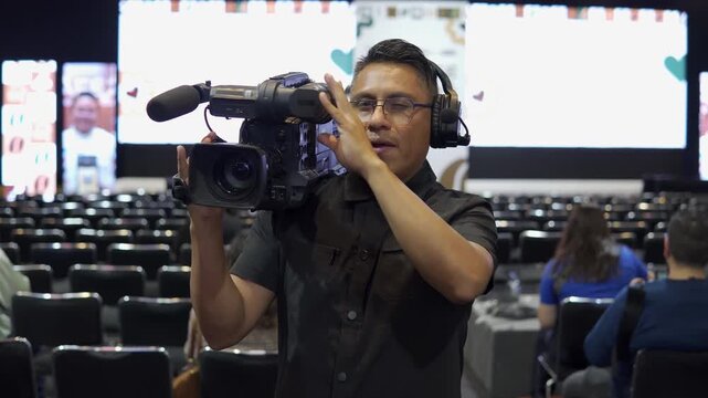 Professional latino camera operator broadcasting live event
