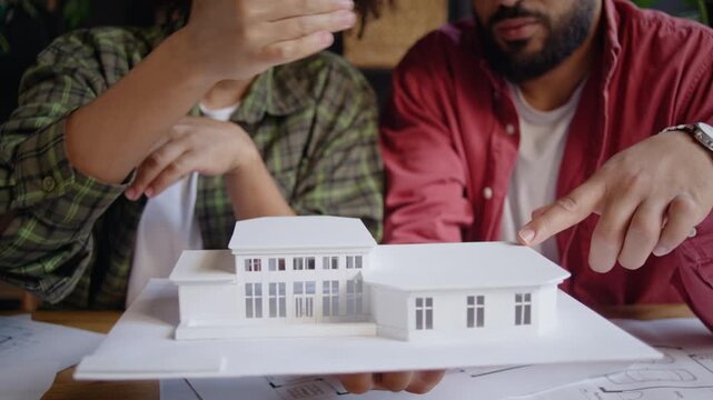 Architects present small house model during close review