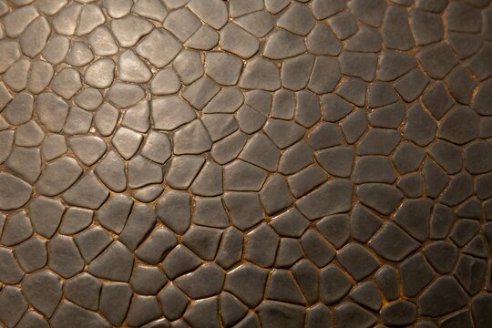 Brown faux leather texture background with embossed pebble flagstone pattern