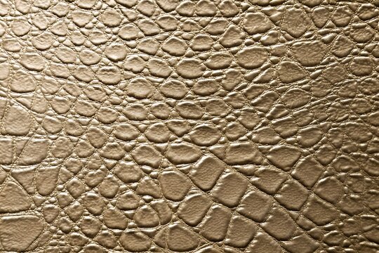 Beige faux crocodile leather texture background with embossed reptile pattern