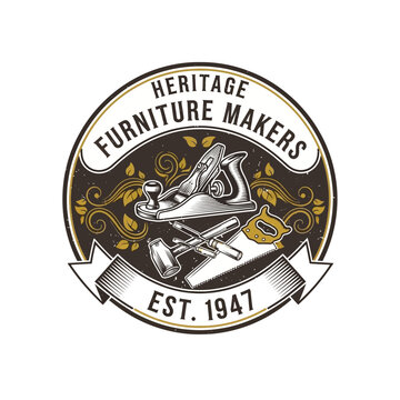 Vintage heritage furniture makers logo emblem with woodworking tools and ornate filigree.