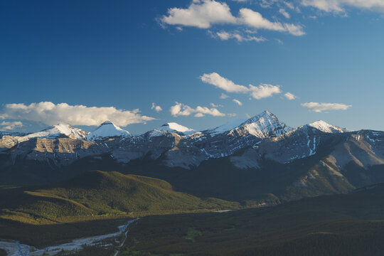 Beautiful views of the Canadian Rockies with picturesque clouds and rivers in the distance 