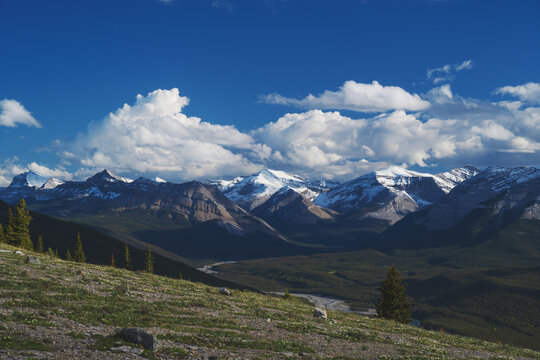 Beautiful views of the Canadian Rockies with picturesque clouds and rivers in the distance 