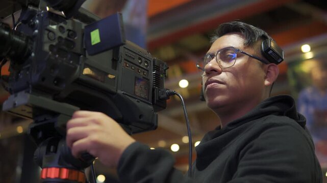 Professional camera operator filming television broadcasting