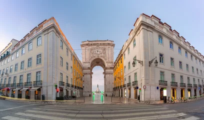 Rua Augusta Arch viewed at dawn from the entrance to Commerce Square in central Lisbon, Portugal. © Kavalenkava