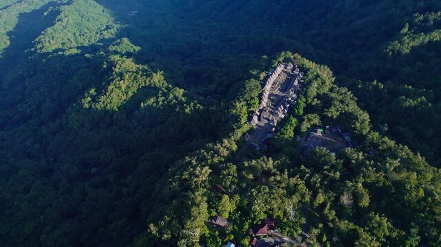 Aerial view of Bena Traditional Village with its iconic thatched roof houses on a mountain ridge in Kecamatan Jerebuu, Nusa Tenggara Timur, Indonesia.