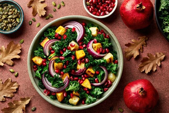 Salad with kale and roasted squash with pomegranate for a healthy autumn meal