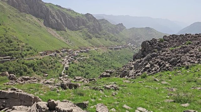 A stone mountain village rests in a lush green valley, framed by rocky slabs and steep highland ridges beneath a soft spring sky.
📍 Waysia village, Hawraman Takht, Kurdistan 