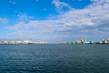 Fototapeta premium Coastal Industrial Landscape with Ships and Harbor Facilities