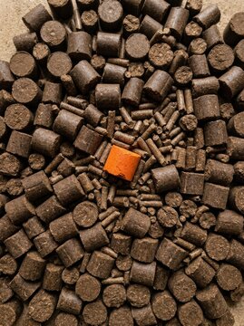 Compressed livestock mineral feed blocks and silage pellets with a single orange accent for ranching and animal husbandry advertising