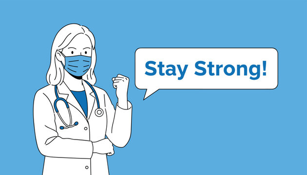 Confident female doctor wearing a surgical mask and stethoscope making a strong fist to motivate patients to stay strong.