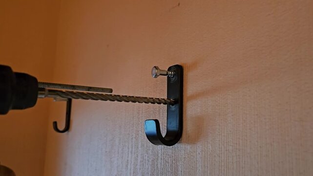 Learn how to install a hook on a wall using a drill and a simple process in a few easy steps