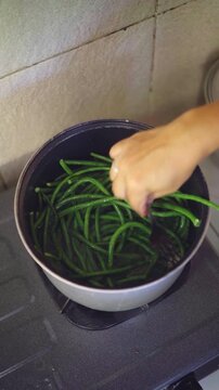 Boiling long beans in the pot to make it soft and easy to cut. 4K Vertical footage. Culinary concept