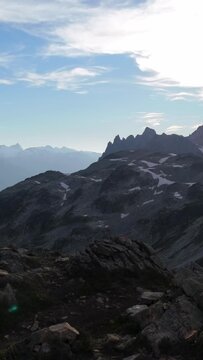 Majestic Mountain Landscape with Snow Patches Under a Blue Sky in British Columbia, Canada