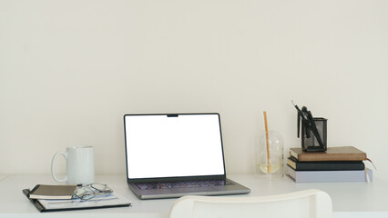 Fototapeta premium Modern laptop mockup on a bright white desk, ideal for website display, online work, digital design, and branding concepts.