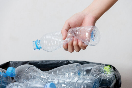 Plastic bottles in black garbage bags waiting to be taken to recycle.