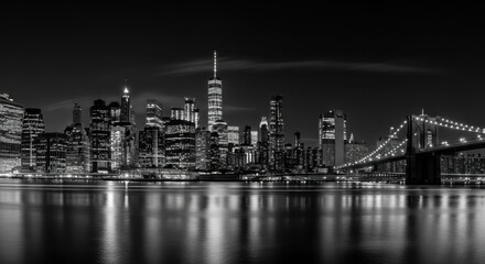 Fototapeta premium Panoramic Black and White Night View of Lower Manhattan Skyline and Brooklyn Bridge with Water Reflections