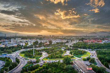 Obraz premium Sunset over Beijing, China; Changping Xiguan Island modern traffic interchange; Xishan Mountain background.