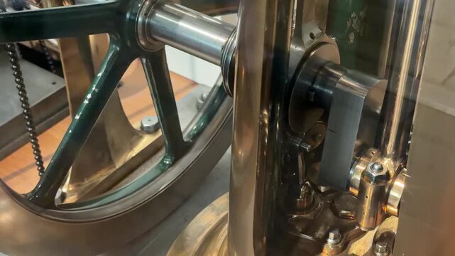 Close Up of a Vintage Steam Engine Piston and Flywheel Rotating