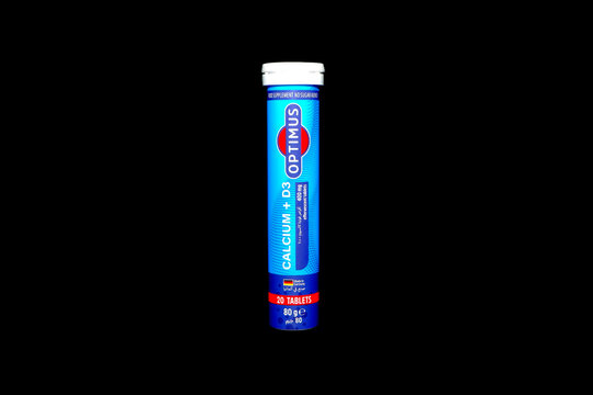 Optimus calcium and d3 effervescent tablet tube standing upright against a black background representing health wellness nutrition mineral supplement and daily dietary 
