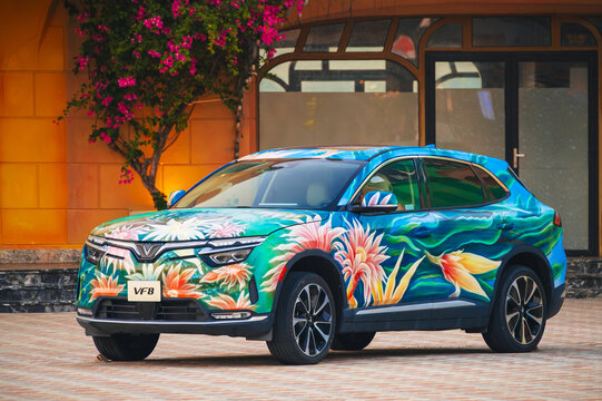 Modern Vietnamese electric car Vinfast VF8 painted with graffiti on display at Vinpearl Amusement Park. Nha Trang, Vietnam - April 1, 2026