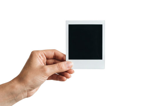 A hand holding a blank polaroid photo frame