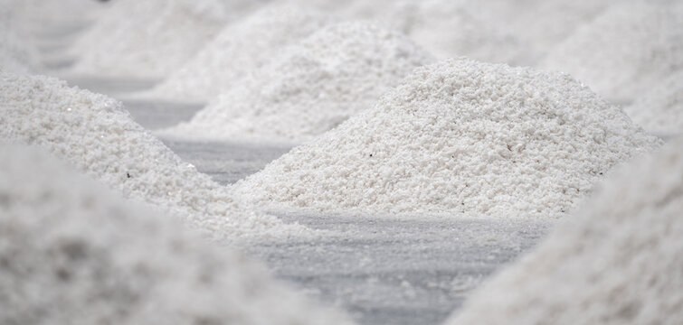 Sea salt farm. Pile of brine salt. Raw material of salt industrial. Sodium Chloride mineral. Evaporation and crystallization of sea water. White salt harvesting. Agriculture industry. Traditional farm