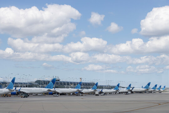Chicago, IL, USA - Aug 31, 2025: A fleet of commercial aircrafts operated by United Airlines are seen parked at terminal gates in Chicago O'Hare International Airport (ORD).