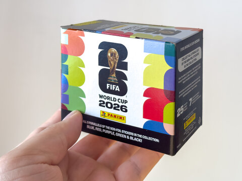 Calgary, Alberta, Canada. June 16, 2026. A hand holds an official Panini FIFA World Cup 2026 sticker box showcasing the tournament logo.