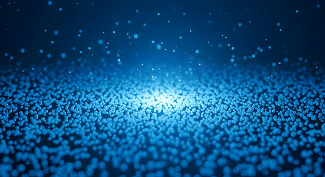 Glowing blue light shines through numerous small particles on a dark surface.