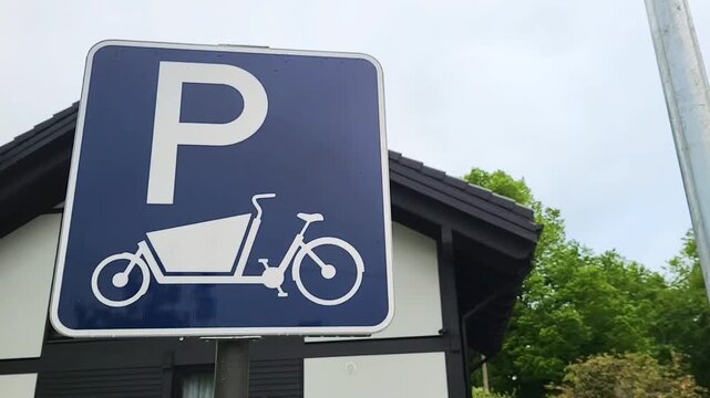road  sign bike with a front child seat bicycle parking white on blue riding going allowed beware