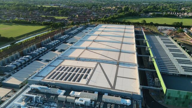 Aerial view of the Google Data Centre in Waltham Cross featuring solar panels and cooling infrastructure near residential areas in Cheshunt, England, United Kingdom.