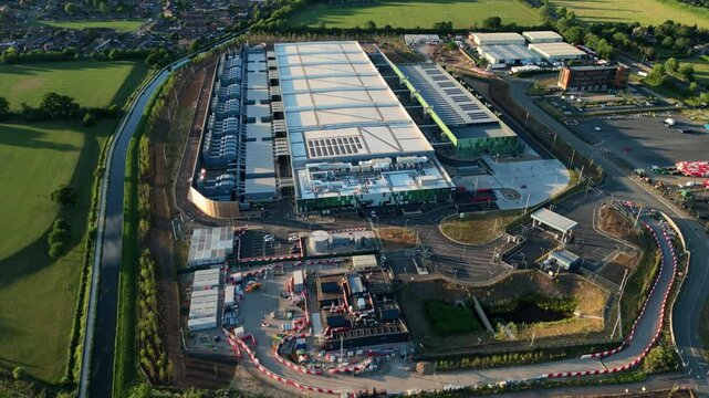 Aerial view of the Google Data Centre in Waltham Cross featuring industrial rooftops, cooling systems, and surrounding green fields in Cheshunt, England, United Kingdom.