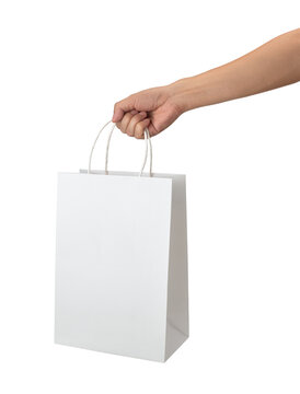Close-Up of Hand Holding White Paper Shopping Bag Isolated on White Background