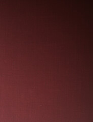 Fototapeta premium Dark maroon canvas texture background with premium fine fabric linen pattern and moody lighting gradient