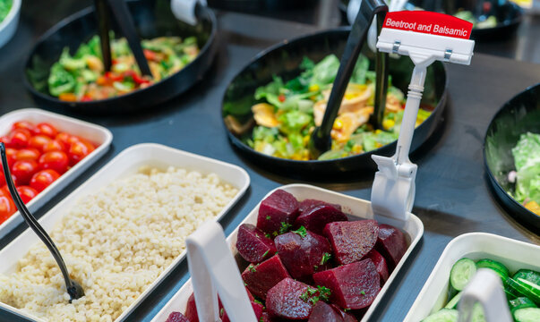 Salad bar buffet at restaurant. Fresh salad bar buffet for lunch or dinner. Healthy food. Beetroot and balsamic in bowl on counter. Catering food. Vegetarian food. Healthy eating. Plant-based diet.