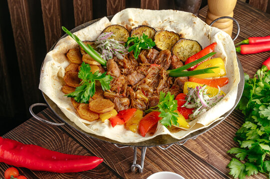 A hearty platter of stewed meat with grilled vegetables