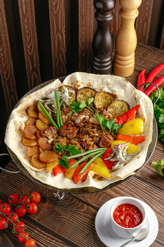 Delicious sadj platter with meat and roasted vegetables