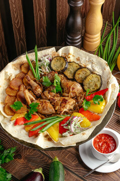 Traditional chicken saj platter with roasted vegetables