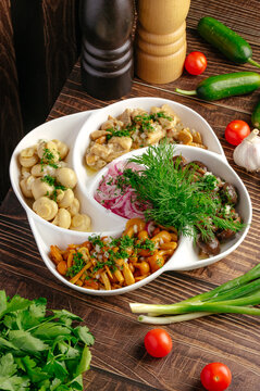 Assorted marinated mushroom appetizer platter on table